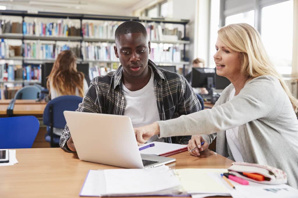 College Student Has Individual Tuition From Teacher In Library